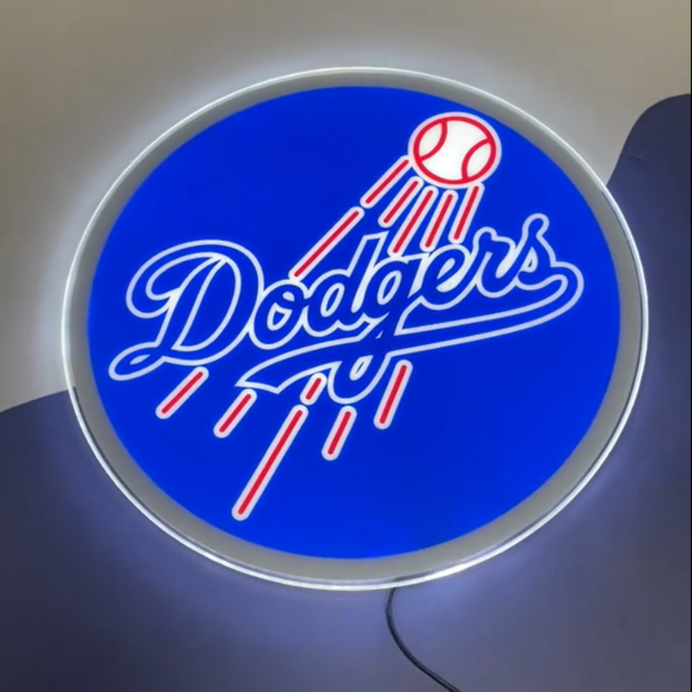 Illuminated Dodgers neon sign featuring blue background and baseball graphic, perfect for fan caves or sports decor.