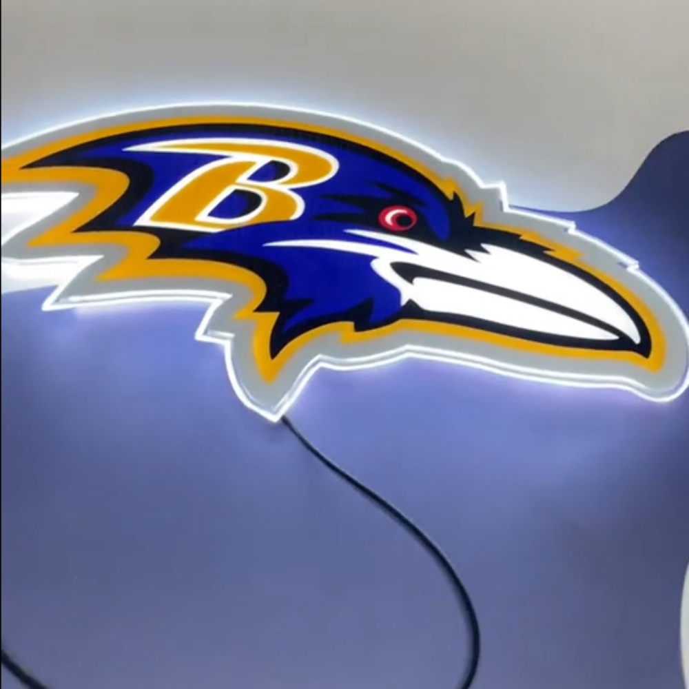 Illuminated Baltimore Ravens neon sign showcasing team logo in vibrant colors, perfect for sports fans.
